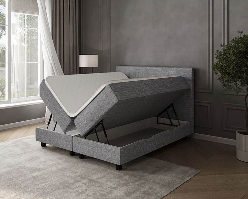 Sofabed med opbevaringsfunktion i moderne grå stof, tilpasset til master bedroom.